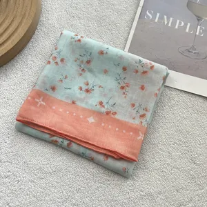 Floral cotton linen neck scarf with blue base and orange borders on modern background