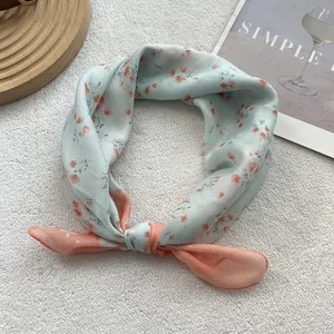 Close-up of floral cotton linen neckerchief with mint green and orange dual-tone design