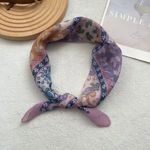 Detailed view of soft purple paisley cotton linen scarf on white plush background