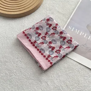 Close-up of floral cotton linen scarf with purple flowers and red diamond border