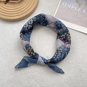 Flat lay of a floral blue cotton linen scarf with soft translucent fabric and vintage pattern