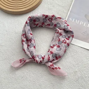 Detail of pink floral cotton linen scarf with fine stitched edges and soft texture