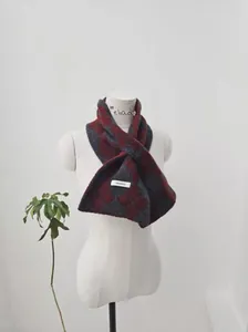Macro shot of 100% pure wool red and grey diamond patterned scarf with logo detail