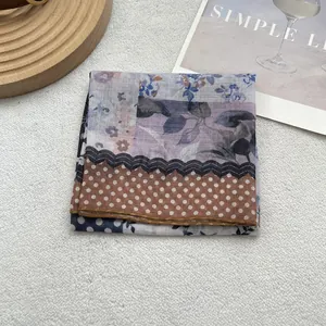 Detail of vintage cotton linen head scarf showing patchwork floral and polka dot patterns