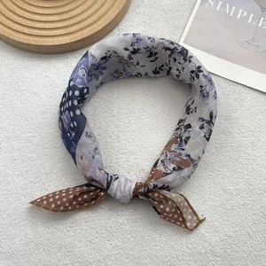 Detail of vintage patchwork scarf with floral and polka dot patterns in a knotted loop