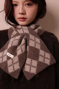 Detail of 100% pure wool scarf tag showing premium diamond lattice knitting texture