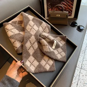 Detail view of the 100% pure wool label on a vintage brown diamond lattice knit scarf