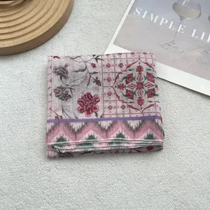 Detail of vintage floral cotton linen scarf with hemmed edges and geometric patterns