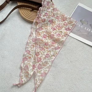 Detail of tulip floral print on breathable cotton linen head scarf with pink stitched edges