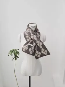 Close-up of argyle knit wool scarf featuring brown and grey textured patterns with label