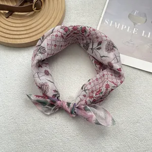 Close-up of vintage floral cotton linen square scarf with pink pattern and rolled edges