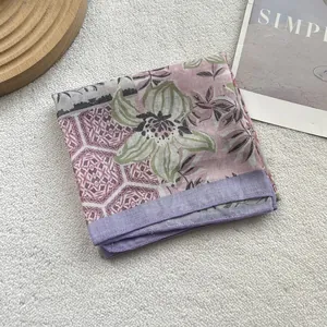 Detailed texture of cotton linen floral scarf with purple honeycomb edge on beige carpet