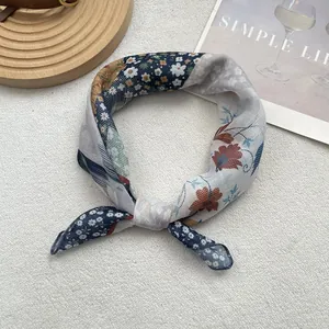 Close-up of floral plaid cotton linen scarf with breathable texture and knot detail