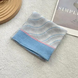 Macro detail of retro blue striped cotton scarf with fine stitching and soft texture