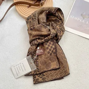 Detail of vintage floral cotton scarf with black rose patterns and washing instructions