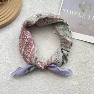 Detail of floral printed cotton linen scarf showing intricate patterns and smooth texture