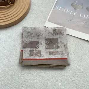 Detail of vintage plaid cotton linen scarf with red stripes and golden stitched edges