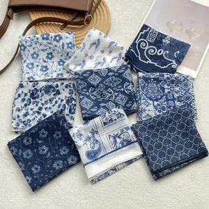 Elegant blue and white floral square scarves display in various patterns and prints