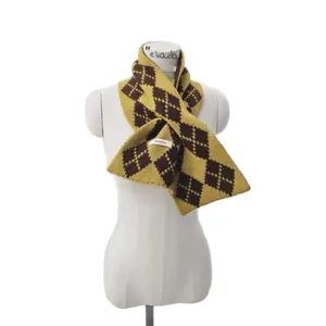 Knitted wool scarf with mustard yellow and brown argyle pattern on a white mannequin