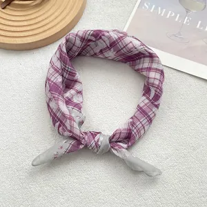 Close-up of knotted silk scarf featuring high-saturation purple and grey plaid pattern