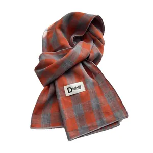 Long cotton scarf featuring a stylish orange and grey plaid pattern with edge stitching