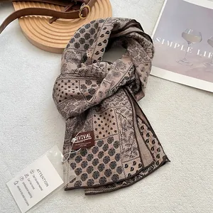 Detail of vintage floral cotton scarf with revival brand tag and care instructions card