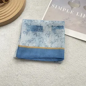 Detailed view of a vintage plaid cotton linen square scarf with blue abstract patterns