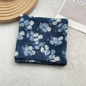 Detail of blue and white tulip floral pattern on a thin lightweight square silk scarf