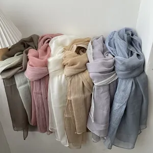 Long pleated mixed-blend scarf in olive, pink, and lilac with a soft crinkled texture