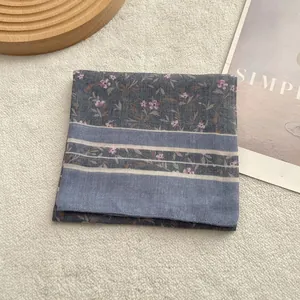 Close-up of vintage cotton linen scarf showing purple floral prints and blue stripes