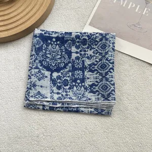 Detail of blue and white floral silk scarf with fine stitching and patchwork patterns