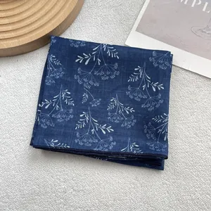 Detail of blue and white floral silk scarf showing cotton linen texture and edge stitching
