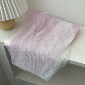 Detail of pink and white gradient pleated scarf with fine dots and textured fabric