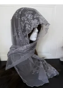 Detail of gray lace scarf with floral embroidery and pearls on delicate mesh fabric
