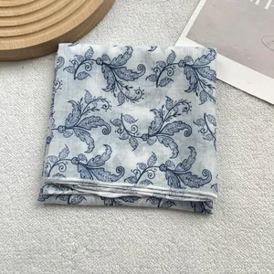 Detailed view of blue floral silk scarf with refined stitching on premium soft fabric
