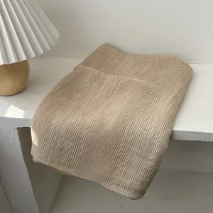 Detail of light khaki pleated fabric texture with elegant vertical organ-style folds