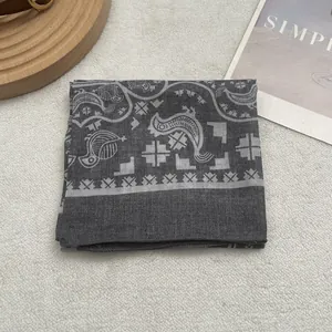 Close-up of dark grey Egyptian mythical print cotton scarf on cozy white fleece