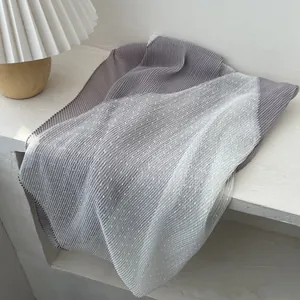 Detail view of long pleated scarf with grey and polka dot blue ombre stitching design