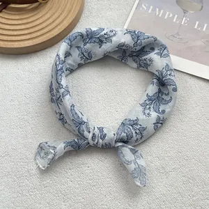 Detailed macro shot of blue floral print cotton-linen scarf with visible fabric texture