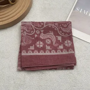 Detailed close-up of ethnic Egyptian print cotton scarf in dark red with geometric bird motifs