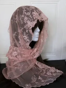 Detailed view of pink floral lace scarf with embroidery and scalloped edge on mannequin