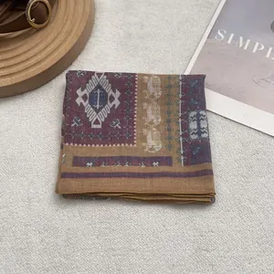 Detailed view of bohemian floral print scarf with ethnic elephant patterns and rolled edges