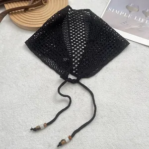 French retro black hollow knit bandana with bohemian beaded ties on white plush surface