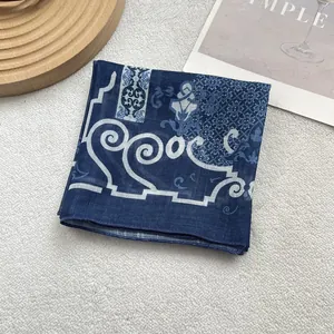 Detail of light blue floral silk scarf showing fine stitching and baroque patterns