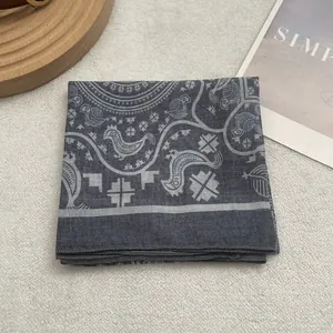 Detail of dark grey Egyptian mythological print scarf showing refined ethnic patterns