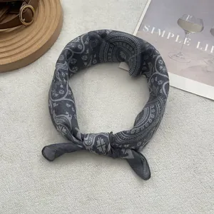 Close-up of dark grey paisley pattern fabric headband with ethnic geometric floral prints