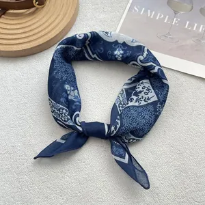 Close-up of blue floral silk scarf featuring bohemian prints and a lightweight texture