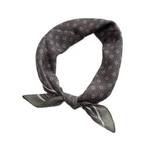 Dark gray small square silk scarf featuring a white geometric diamond pattern in a knot