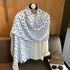 Long white cotton scarf for women featuring blue heart patterns and tassel accents
