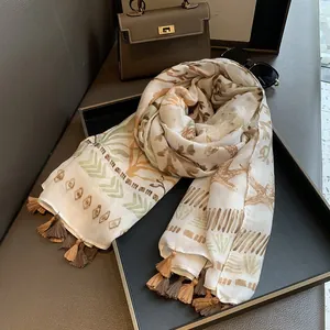 Detailed view of printed cotton linen scarf with tassels and abstract nature patterns